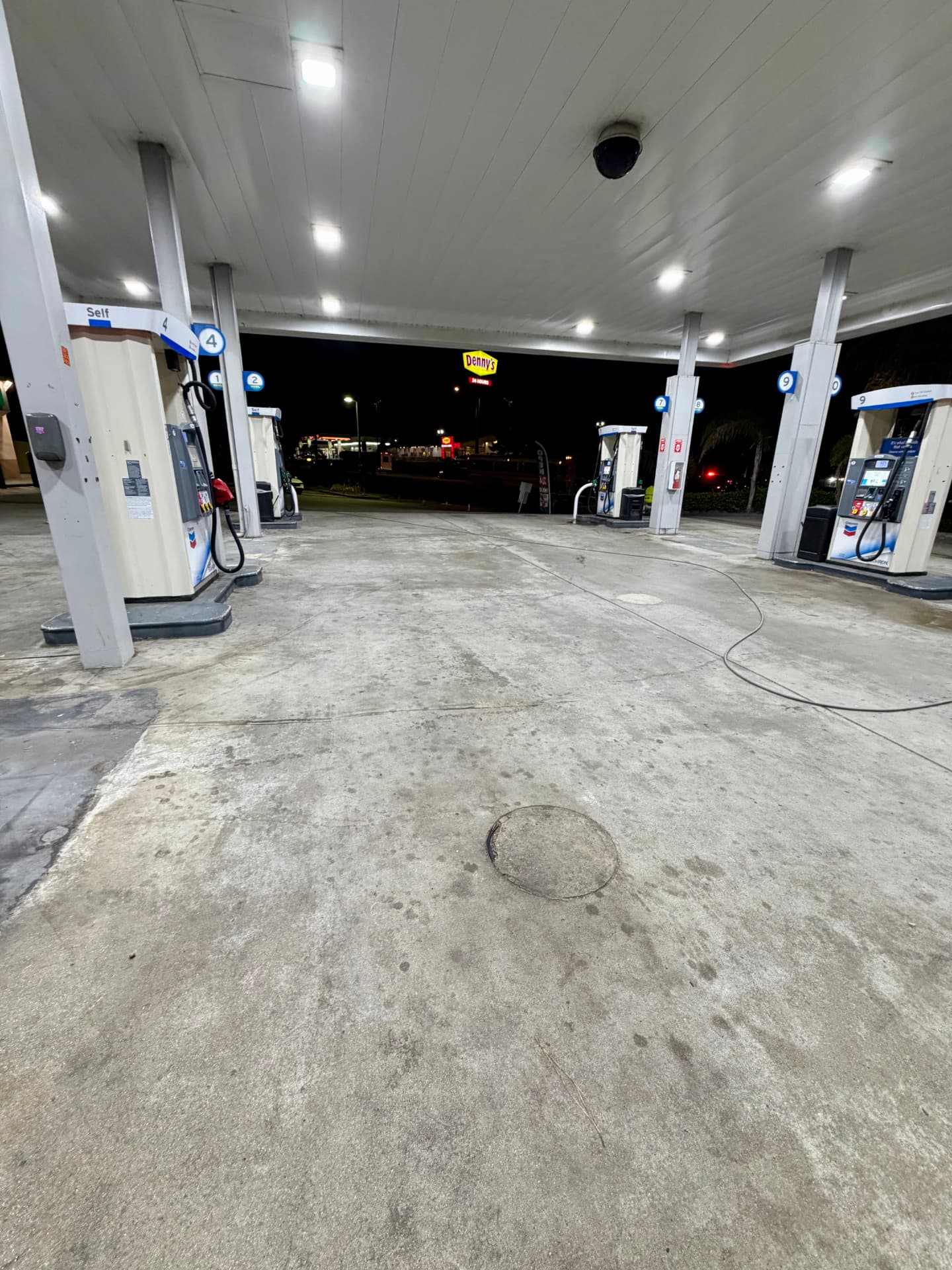 KleanPoint crew equipment staged at a fuel station canopy at night